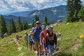A happy guide and a couple families walking a mountain trail in Colorado